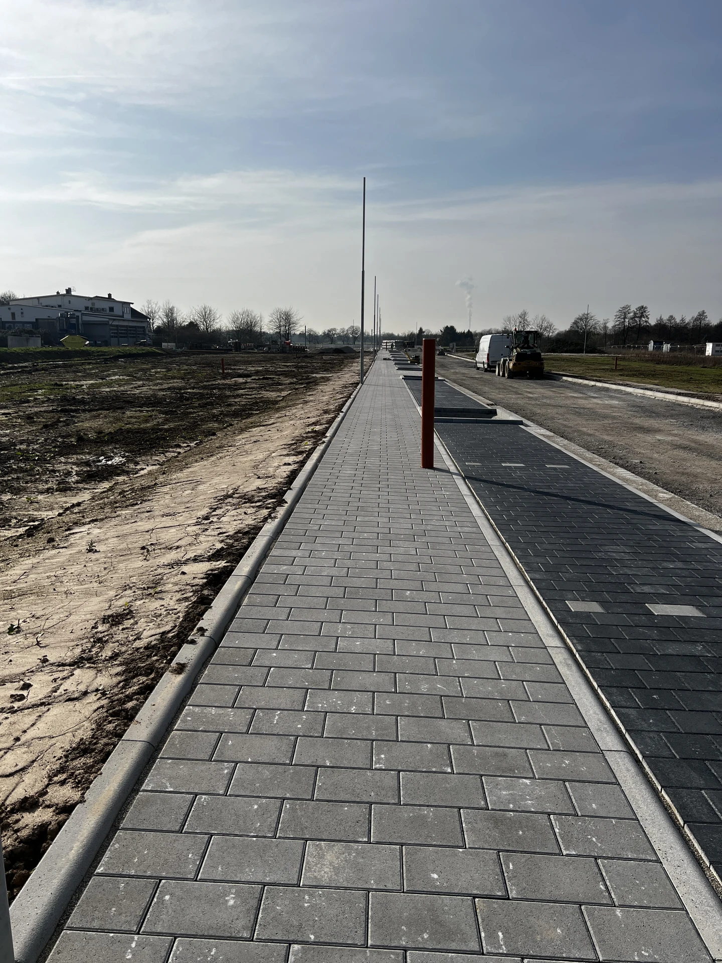 Neuer Gehweg mit Bordstein entlang der Fahrbahn